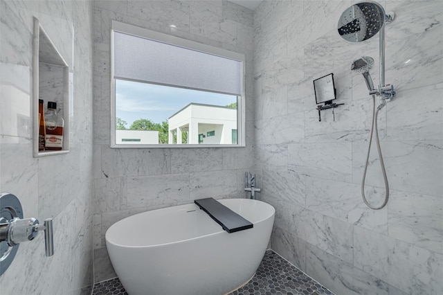 full bathroom featuring a soaking tub, tile walls, and a tile shower