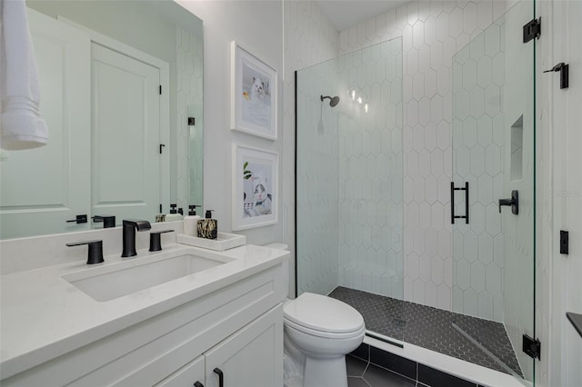 bathroom with a shower stall, tile patterned floors, vanity, and toilet