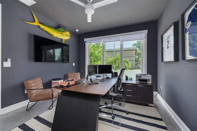 tiled office with baseboards and a ceiling fan