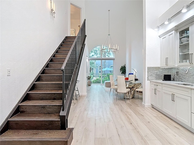 700 S Harbour Island Blvd Unit 143, Tampa, FL 33602 - staircase featuring a towering ceiling, wood finished floors, and a notable chandelier