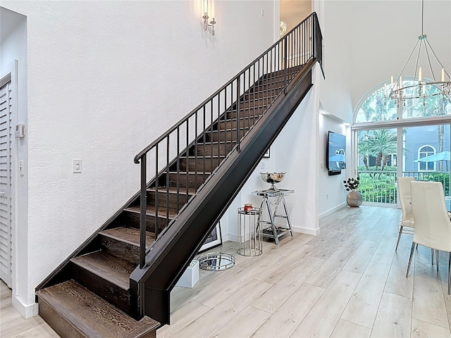 700 S Harbour Island Blvd Unit 143, Tampa, FL 33602 - stairs featuring baseboards, a notable chandelier, and wood finished floors