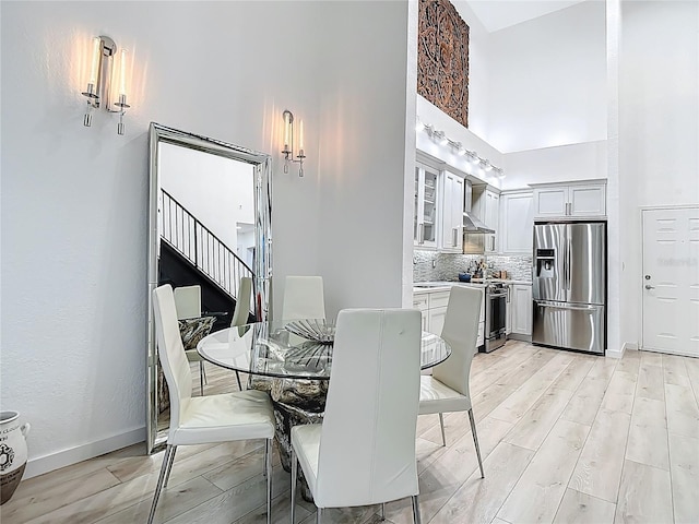 700 S Harbour Island Blvd Unit 143, Tampa, FL 33602 - dining area featuring light wood finished floors, baseboards, and a towering ceiling
