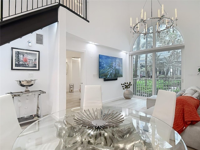 700 S Harbour Island Blvd Unit 143, Tampa, FL 33602 - dining room featuring baseboards, visible vents, a high ceiling, and an inviting chandelier