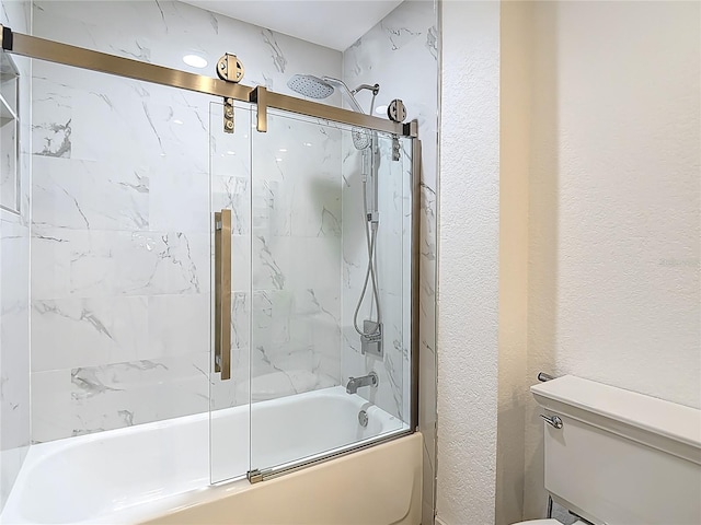 700 S Harbour Island Blvd Unit 143, Tampa, FL 33602 - bathroom featuring combined bath / shower with glass door, a textured wall, and toilet