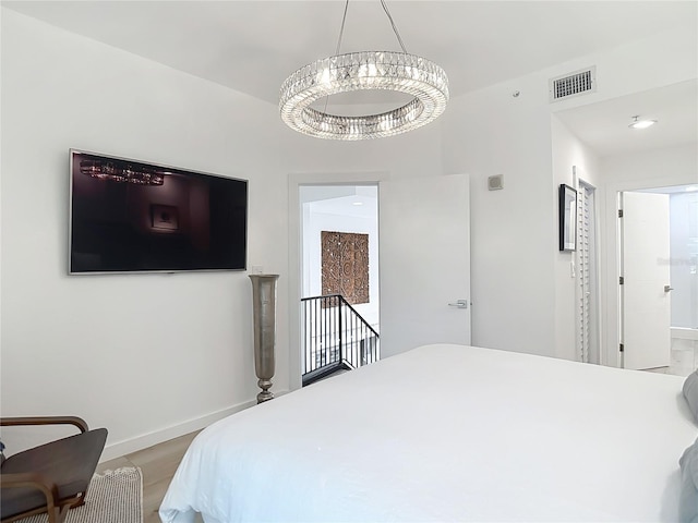 700 S Harbour Island Blvd Unit 143, Tampa, FL 33602 - bedroom with baseboards, visible vents, and a notable chandelier
