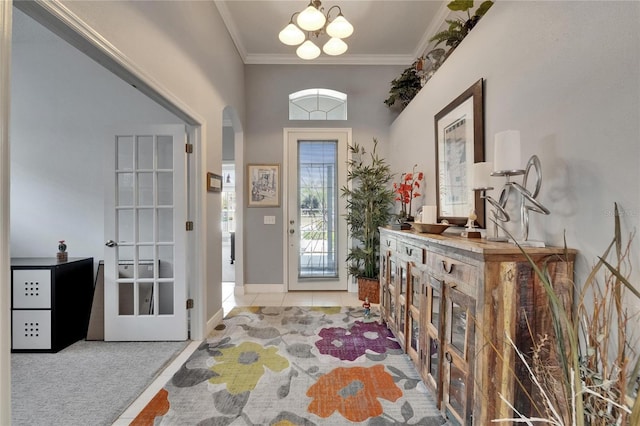 1102 Emerald Dunes Dr, Sun City Center, FL 33573 - carpeted foyer with a chandelier, crown molding, and tile patterned floors