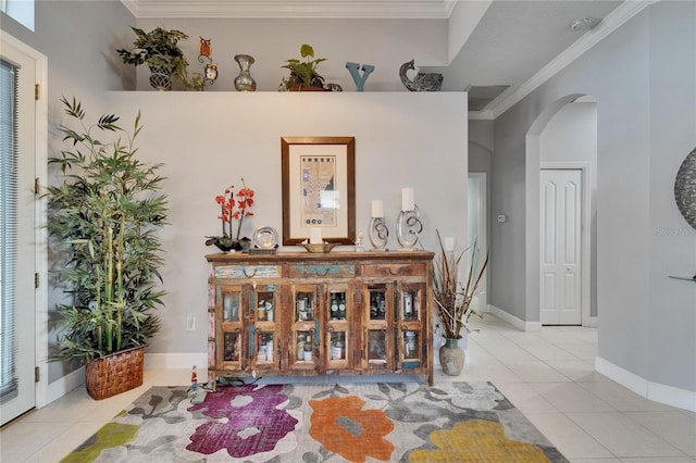1102 Emerald Dunes Dr, Sun City Center, FL 33573 - tiled entrance foyer featuring crown molding, visible vents, baseboards, and arched walkways