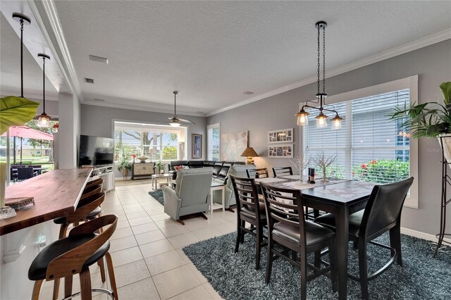 1102 Emerald Dunes Dr, Sun City Center, FL 33573 - dining area featuring visible vents, a textured ceiling, crown molding, and light tile patterned flooring