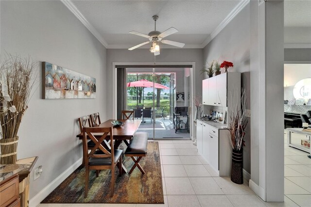 1102 Emerald Dunes Dr, Sun City Center, FL 33573 - dining space featuring crown molding, light tile patterned flooring, ceiling fan, and baseboards