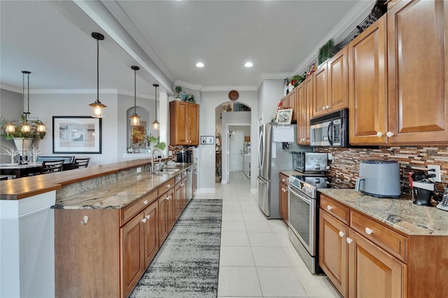 1102 Emerald Dunes Dr, Sun City Center, FL 33573 - kitchen with a sink, light tile patterned floors, backsplash, and appliances with stainless steel finishes