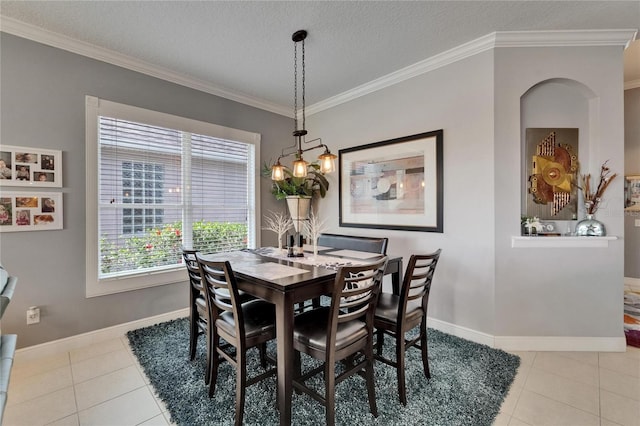 1102 Emerald Dunes Dr, Sun City Center, FL 33573 - dining space featuring tile patterned floors, crown molding, and baseboards