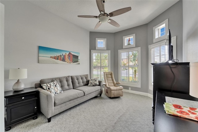 1102 Emerald Dunes Dr, Sun City Center, FL 33573 - carpeted living room with baseboards and a ceiling fan
