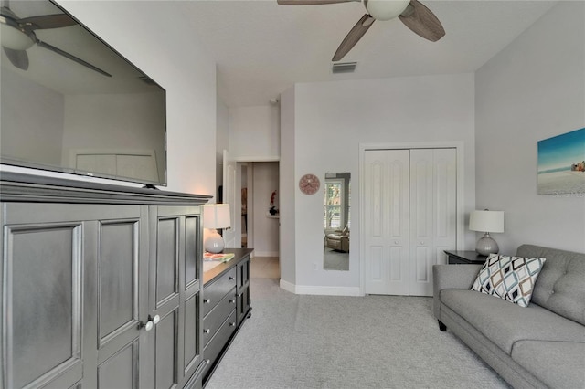 1102 Emerald Dunes Dr, Sun City Center, FL 33573 - living area featuring light colored carpet, baseboards, a ceiling fan, and visible vents