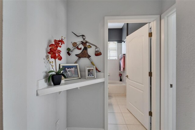 1102 Emerald Dunes Dr, Sun City Center, FL 33573 - corridor featuring light tile patterned floors