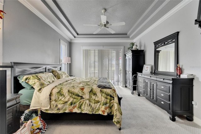 1102 Emerald Dunes Dr, Sun City Center, FL 33573 - bedroom featuring ornamental molding, a ceiling fan, a textured ceiling, a tray ceiling, and light colored carpet