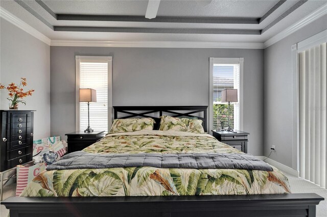 1102 Emerald Dunes Dr, Sun City Center, FL 33573 - carpeted bedroom with a raised ceiling, crown molding, ceiling fan, and baseboards