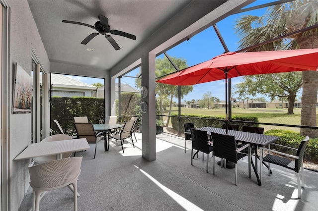 1102 Emerald Dunes Dr, Sun City Center, FL 33573 - sunroom with ceiling fan and outdoor dining area
