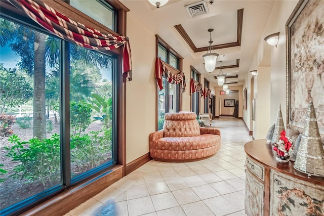 1102 Emerald Dunes Dr, Sun City Center, FL 33573 - hall with visible vents, a tray ceiling, crown molding, and a healthy amount of sunlight