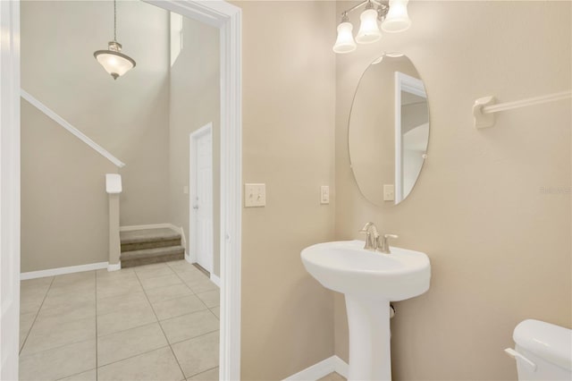 bathroom with toilet, tile patterned floors, and baseboards