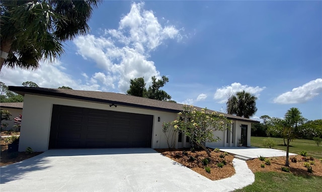 24549 Nova Ln, Punta Gorda, FL 33980 - view of front of property featuring stucco siding, a garage, and driveway
