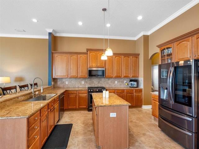 kitchen featuring decorative backsplash, stainless steel appliances, a kitchen island, a sink, and light stone counters