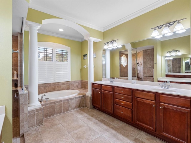 bathroom featuring decorative columns, crown molding, a sink, and a bath