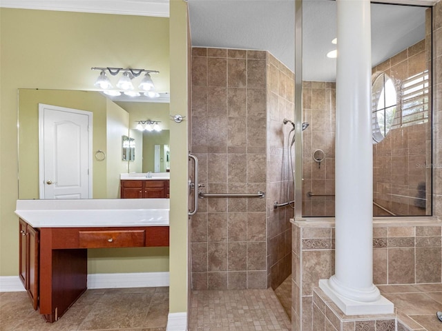 bathroom with tiled shower, tile patterned flooring, and vanity