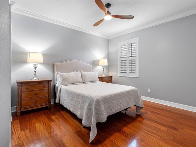 bedroom with baseboards, ornamental molding, wood finished floors, and ceiling fan