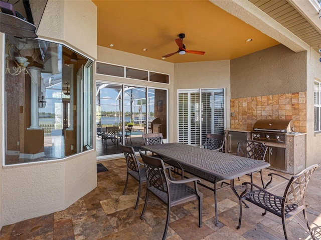 view of patio / terrace with ceiling fan, outdoor dining space, and grilling area