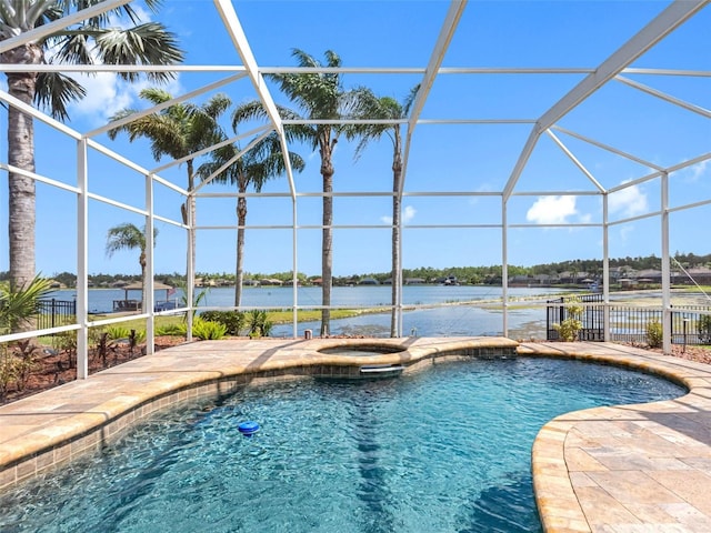 view of pool featuring a pool with connected hot tub, a water view, a lanai, and a patio