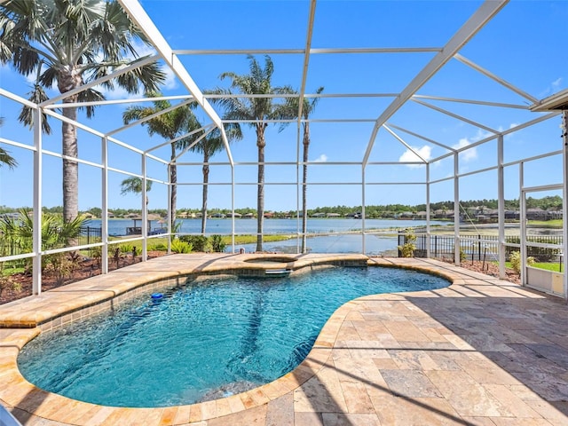 view of swimming pool featuring glass enclosure, a water view, a patio, and a pool with connected hot tub