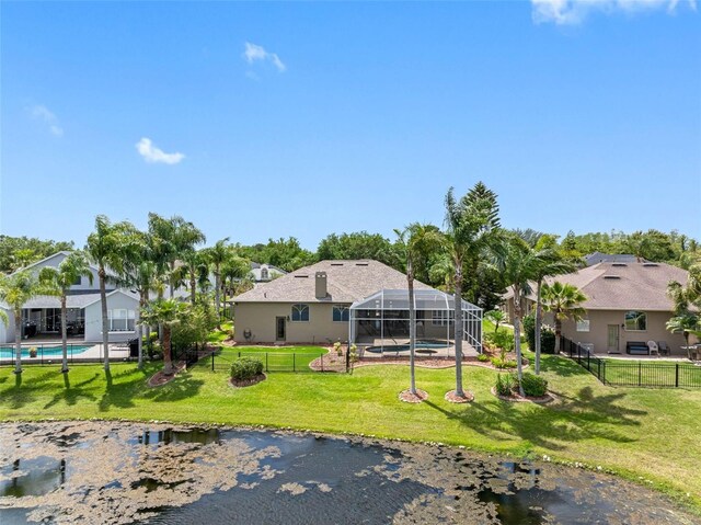 view of yard with a fenced in pool, a fenced backyard, and a lanai