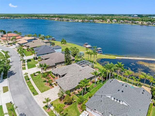 drone / aerial view with a residential view and a water view