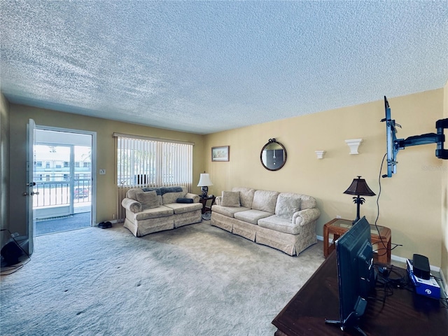 living area with baseboards, carpet floors, and a textured ceiling