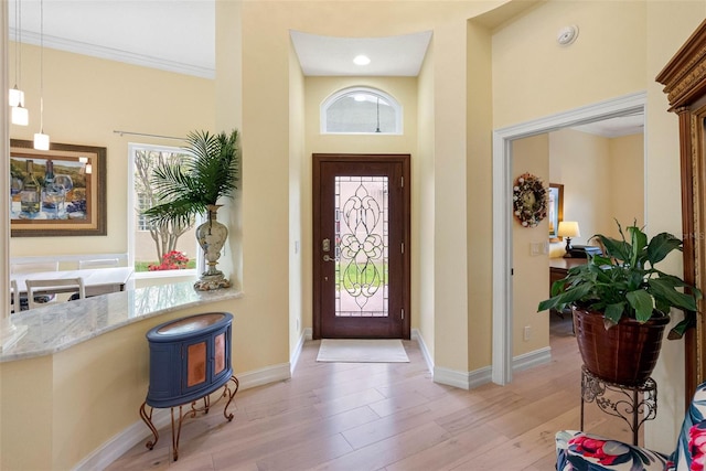 9897 Sago Point Dr, Seminole, FL 33777 - foyer entrance featuring crown molding, baseboards, and light wood finished floors