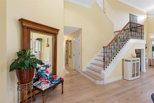 9897 Sago Point Dr, Seminole, FL 33777 - staircase with a high ceiling, ornamental molding, baseboards, and wood finished floors