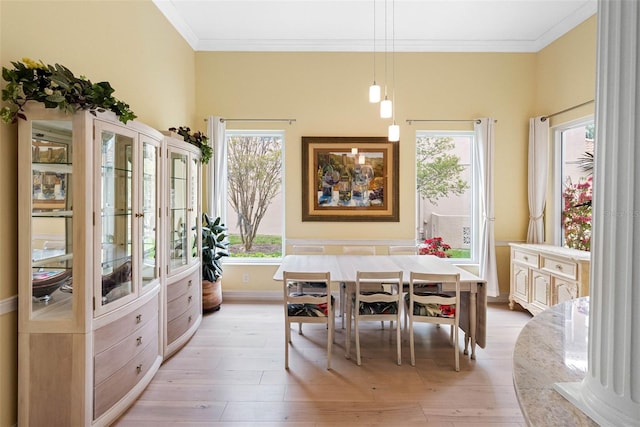 9897 Sago Point Dr, Seminole, FL 33777 - dining room featuring baseboards, light wood-type flooring, and ornamental molding