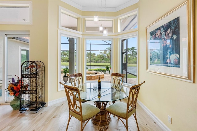 9897 Sago Point Dr, Seminole, FL 33777 - dining space with crown molding, baseboards, and light wood finished floors