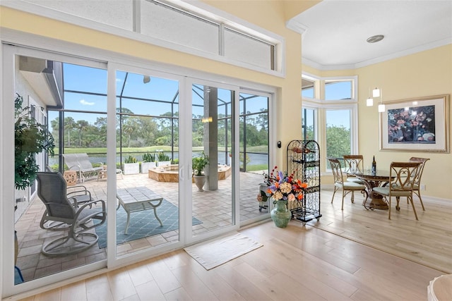 9897 Sago Point Dr, Seminole, FL 33777 - doorway to outside with baseboards, wood finished floors, and crown molding