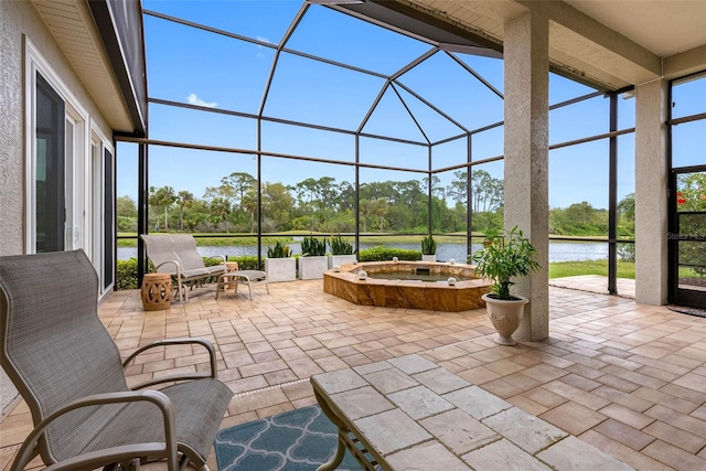 9897 Sago Point Dr, Seminole, FL 33777 - view of patio / terrace featuring an outdoor hot tub, a water view, and a lanai