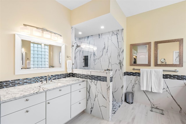 9897 Sago Point Dr, Seminole, FL 33777 - full bath featuring vanity, a marble finish shower, and tile walls