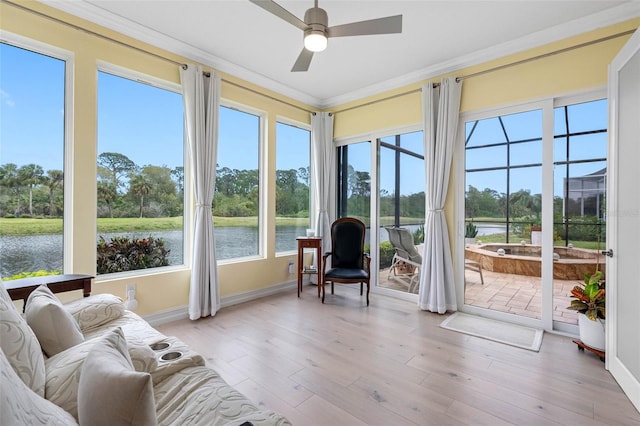 9897 Sago Point Dr, Seminole, FL 33777 - sunroom / solarium featuring baseboards, a water view, ornamental molding, and wood finished floors