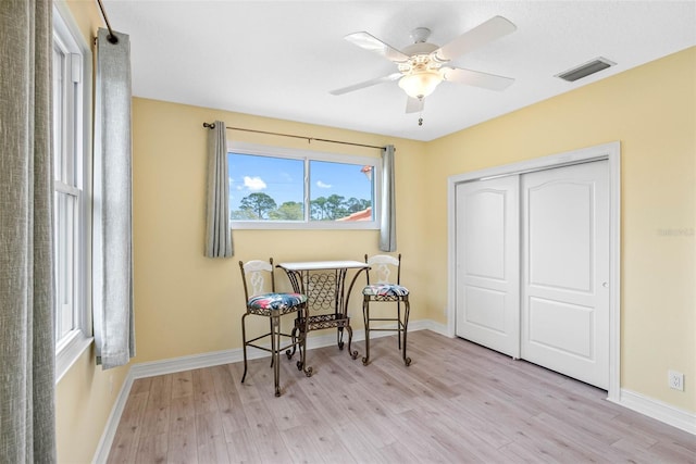 9897 Sago Point Dr, Seminole, FL 33777 - living area with ceiling fan, baseboards, light wood finished floors, and visible vents