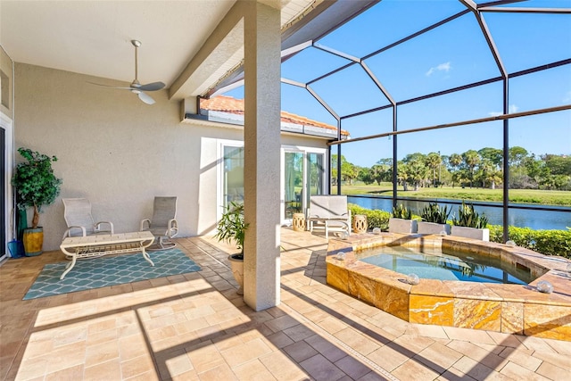 9897 Sago Point Dr, Seminole, FL 33777 - view of patio with a lanai, a water view, a ceiling fan, and an in ground hot tub