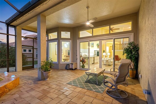 9897 Sago Point Dr, Seminole, FL 33777 - patio terrace at dusk featuring a lanai and a ceiling fan