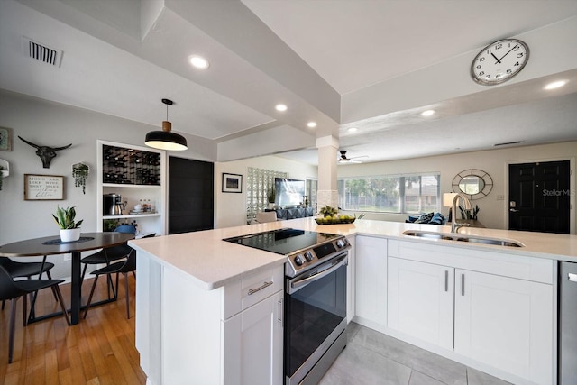 kitchen featuring light countertops, recessed lighting, stainless steel appliances, a sink, and visible vents