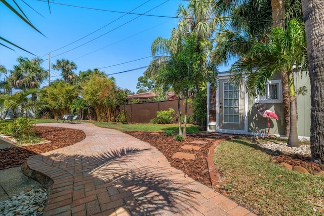 view of yard featuring fence and a patio