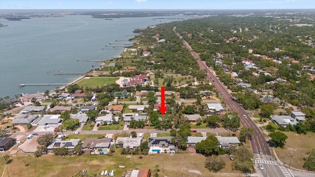 drone / aerial view featuring a residential view and a water view