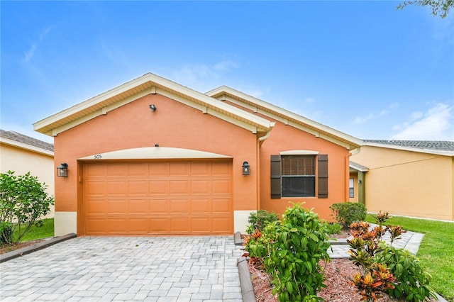 505 Millifiora Ln, Kissimmee, FL 34759 - ranch-style home with stucco siding, a garage, and decorative driveway