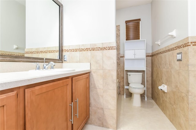 505 Millifiora Ln, Kissimmee, FL 34759 - bathroom with tile walls, tile patterned floors, a wainscoted wall, toilet, and vanity